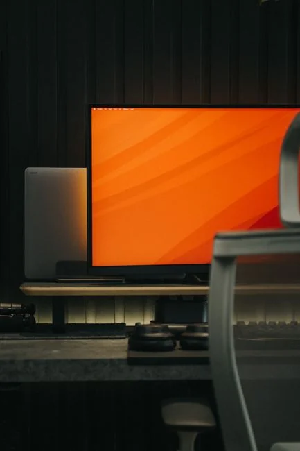 A modern computer screen displaying web design work, showcasing creative visuals in a workspace.
